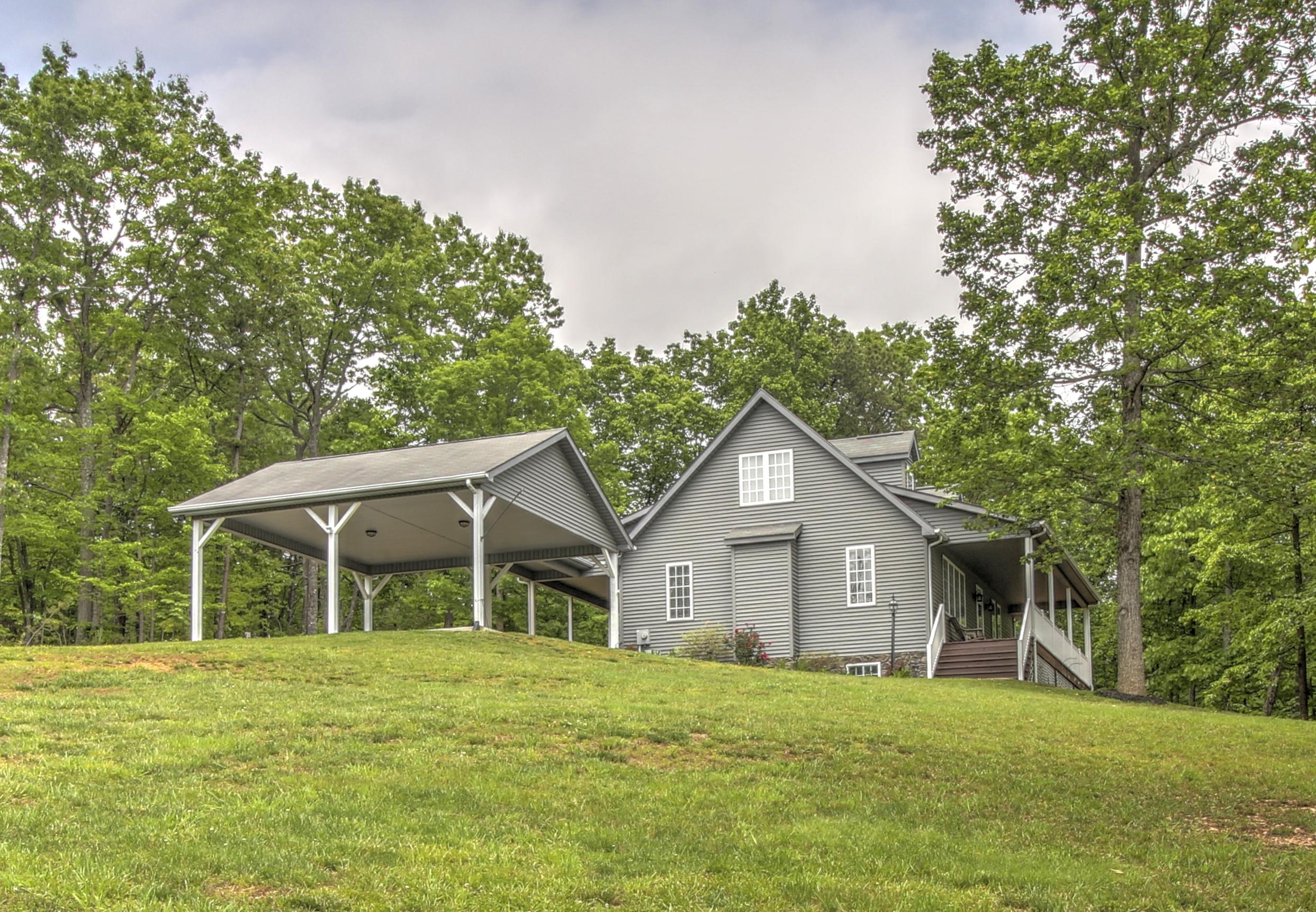 1335 Woodhaven Estates Road Blue Ridge, VA 24064 - Photo 4 of 45 a front view of a house with a yard and trees