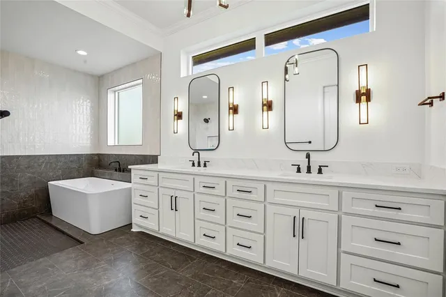 a bathroom with a tub sink and mirror