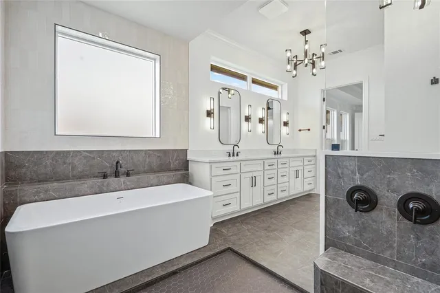 a spacious bathroom with a double vanity sink and a mirror