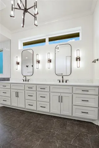 a bathroom with double vanity sink a two mirror a window and vanity
