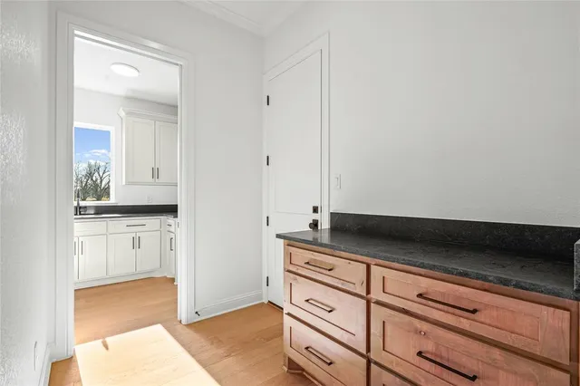 a kitchen with granite countertop white cabinets and a sink