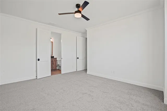 a bathroom with a granite countertop toilet sink and mirror