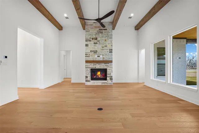 a view of an empty room with a fireplace