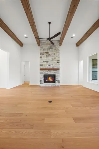 a view of empty room with a fireplace