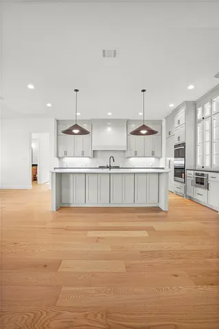 a view of kitchen with wooden floor and windows