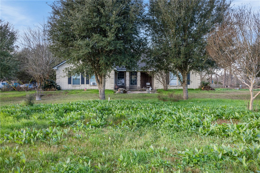 24248 State Highway Navasota, TX 77868 - Photo 3 of 18 a view of a house with a backyard