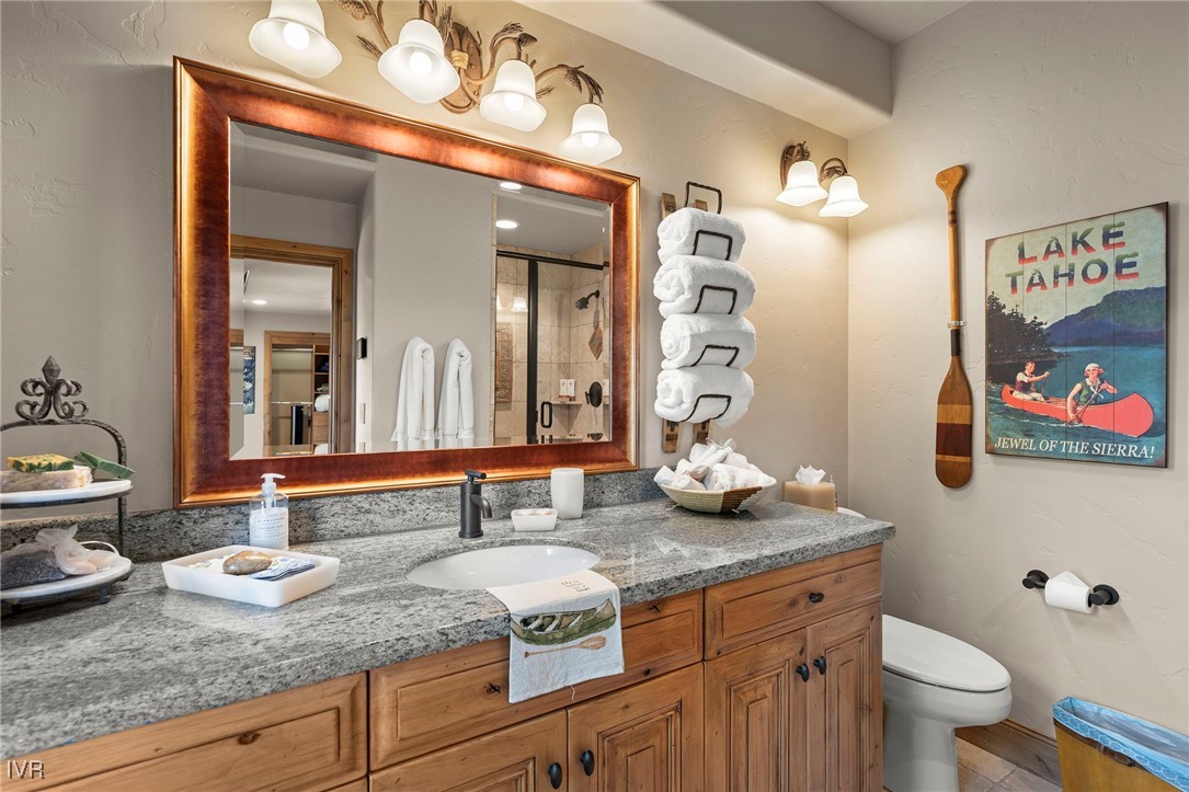 444 Gonowabie Road Crystal Bay, NV 89402 - Photo 30 of 50 a bathroom with a granite countertop sink a toilet and a mirror