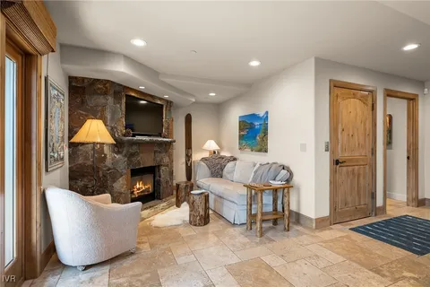 a living room with furniture a flat screen tv and a fireplace