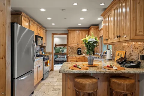 a bedroom with a bed and large windows