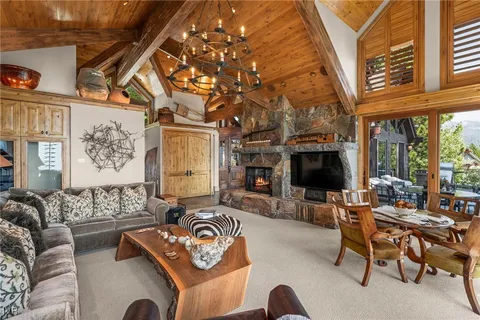 a living room with furniture a flat screen tv and a large window