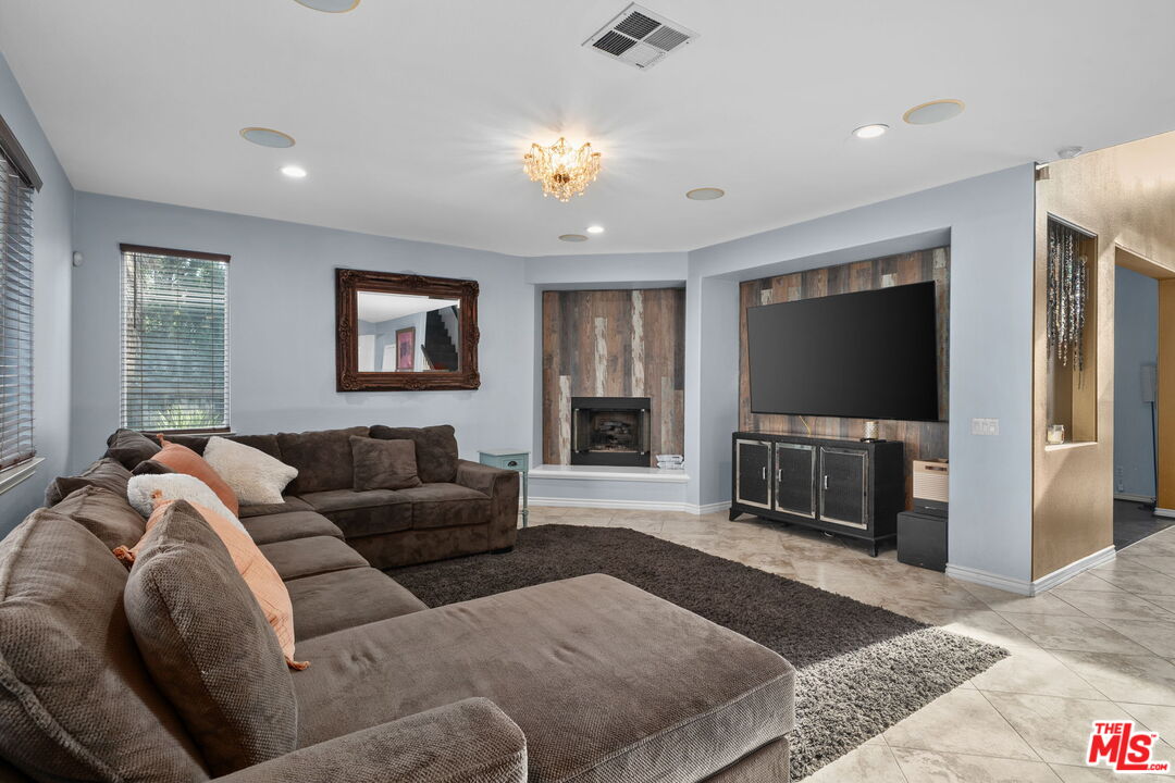 18080 Tanzanite Road San Bernardino, CA 92407 - Photo 11 of 49 a living room with furniture and a flat screen tv