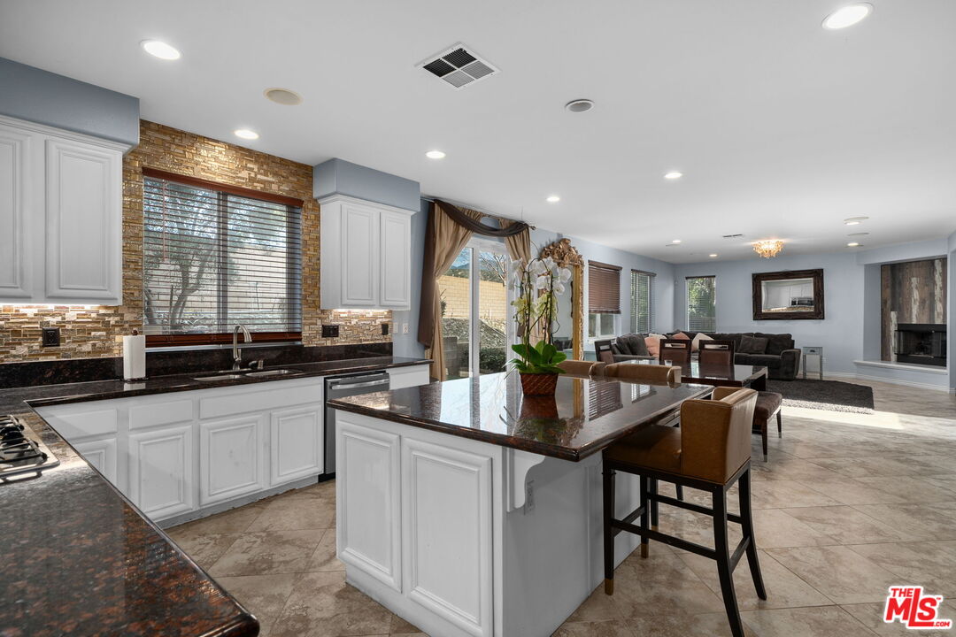 18080 Tanzanite Road San Bernardino, CA 92407 - Photo 16 of 49 a kitchen with center island table and chairs