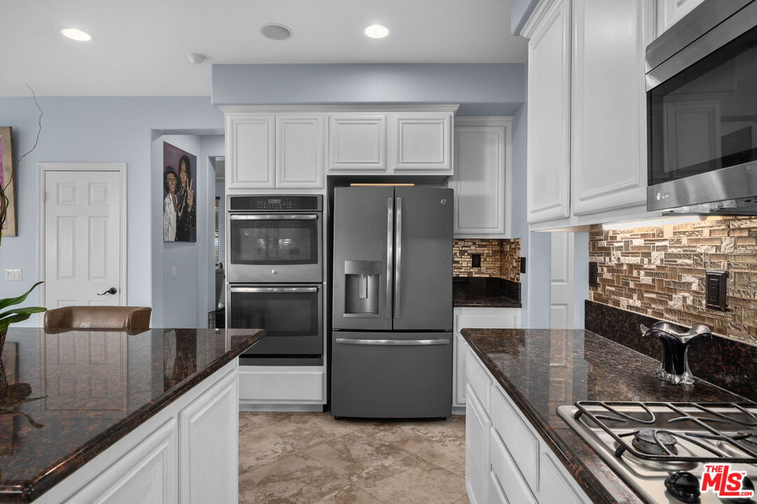 18080 Tanzanite Road San Bernardino, CA 92407 - Photo 19 of 49 a kitchen with stainless steel appliances granite countertop a refrigerator and a sink