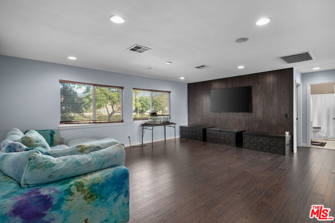 18080 Tanzanite Road San Bernardino, CA 92407 - Photo 21 of 49 a living room with furniture and a flat screen tv