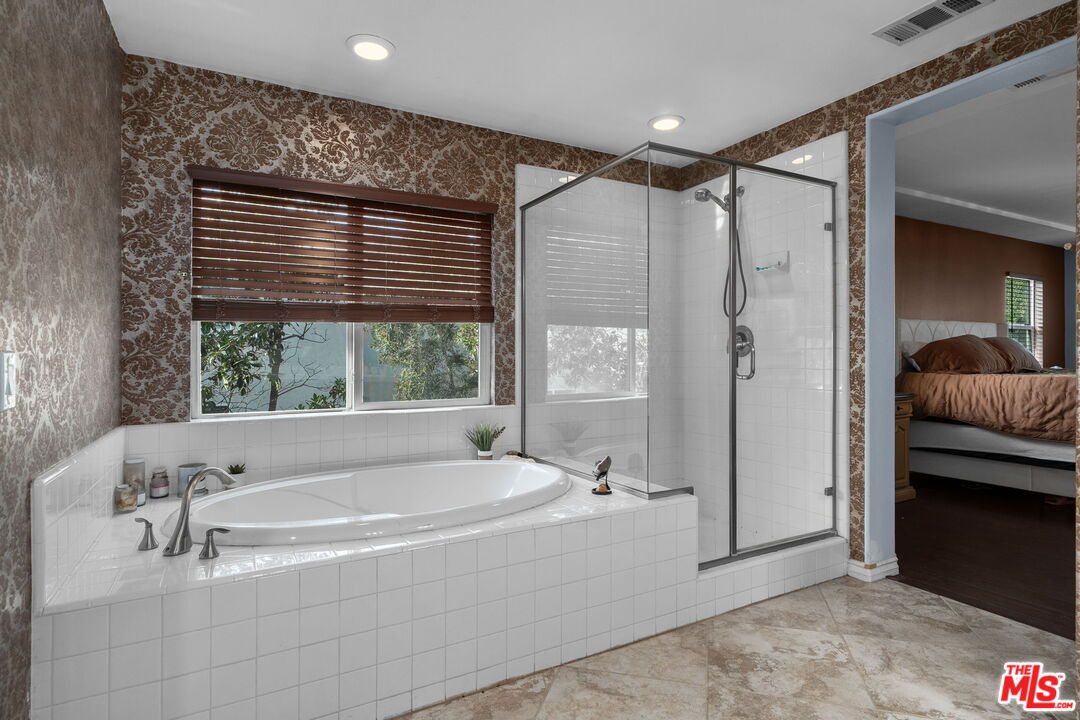 18080 Tanzanite Road San Bernardino, CA 92407 - Photo 28 of 49 a bathroom with a tub and a shower