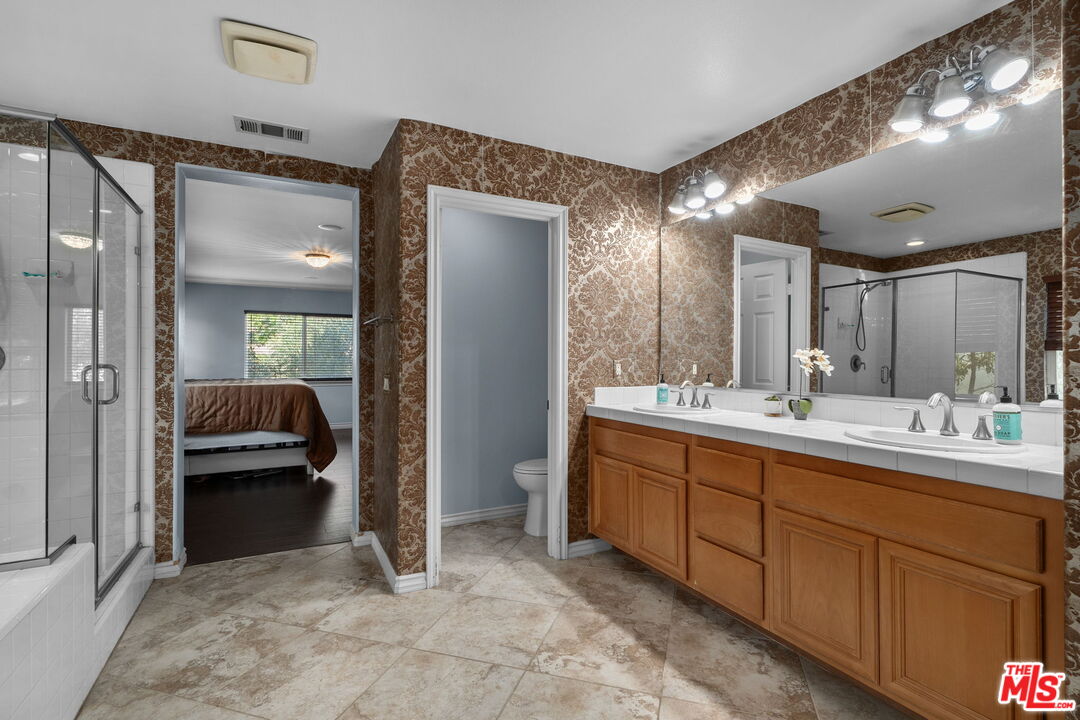 18080 Tanzanite Road San Bernardino, CA 92407 - Photo 29 of 49 a bathroom with a sink and mirror