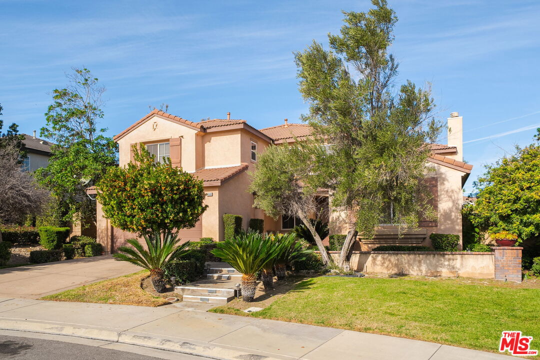 18080 Tanzanite Road San Bernardino, CA 92407 - Photo 3 of 49 a front view of a house with a yard