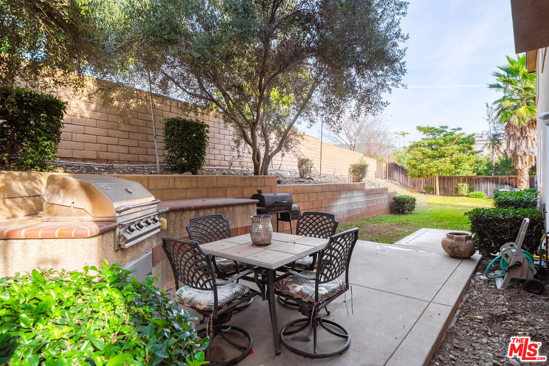 18080 Tanzanite Road San Bernardino, CA 92407 - Photo 36 of 49 a view of a patio with table and chairs and potted plants