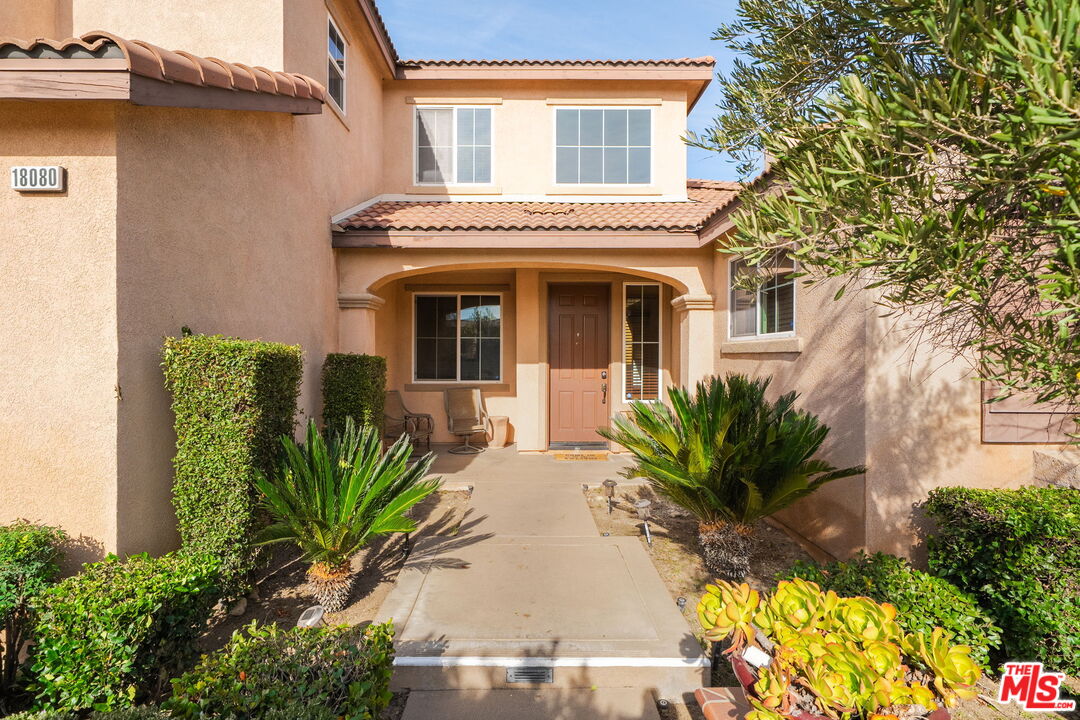 18080 Tanzanite Road San Bernardino, CA 92407 - Photo 4 of 49 a front view of a house with a garden
