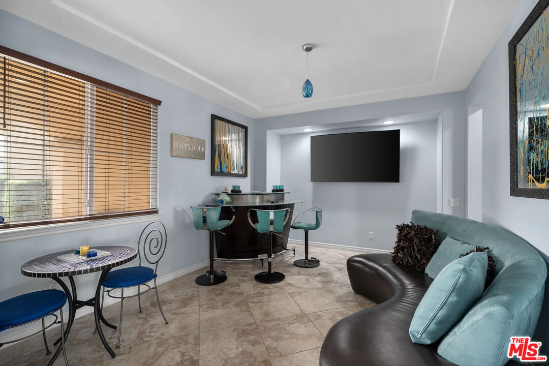 18080 Tanzanite Road San Bernardino, CA 92407 - Photo 9 of 49 a living room with furniture a flat screen tv and a window