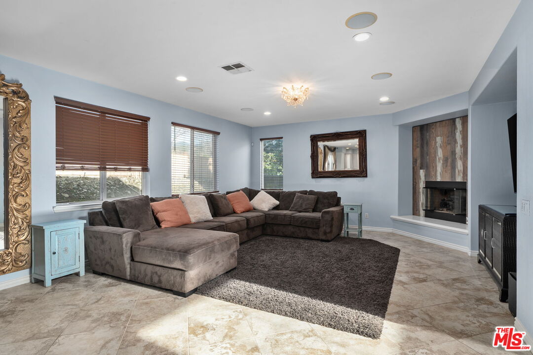 18080 Tanzanite Road San Bernardino, CA 92407 - Photo 10 of 49 a living room with furniture and a flat screen tv