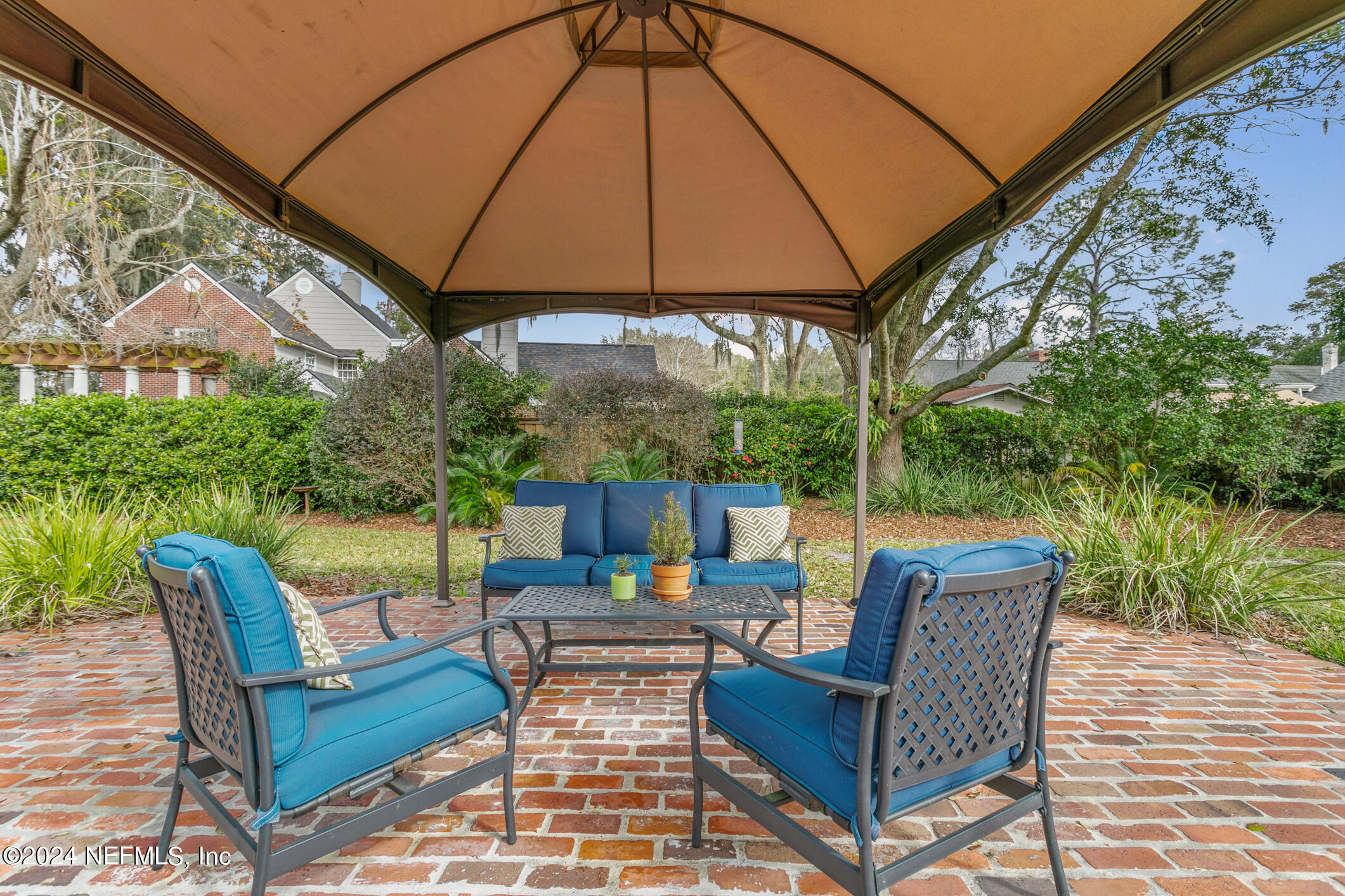 1111 Greenridge Road Jacksonville, FL 32207 - Photo 14 of 73 a view of an outdoor sitting area with furniture and umbrella