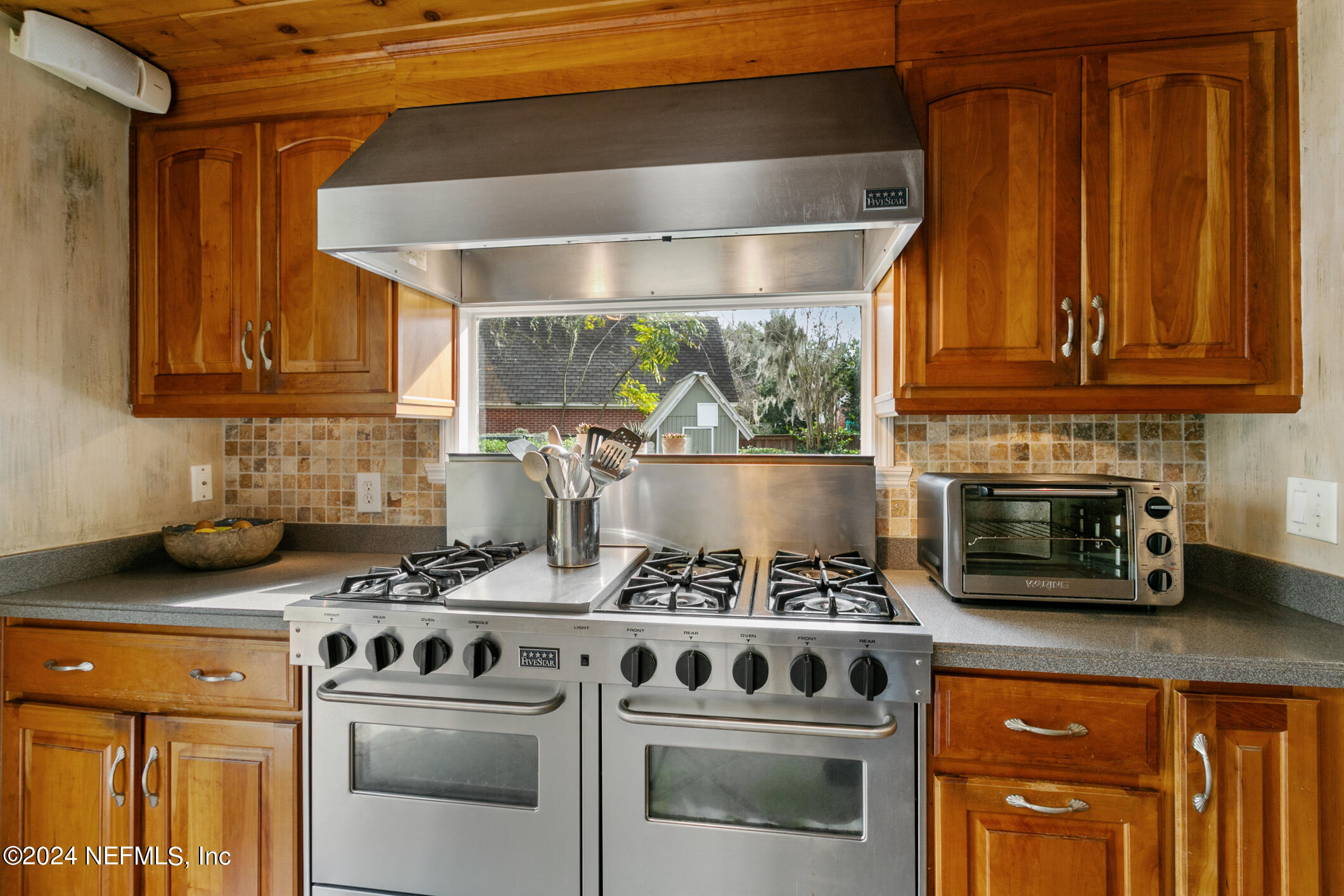 1111 Greenridge Road Jacksonville, FL 32207 - Photo 16 of 73 a kitchen with stainless steel appliances granite countertop a stove and a microwave
