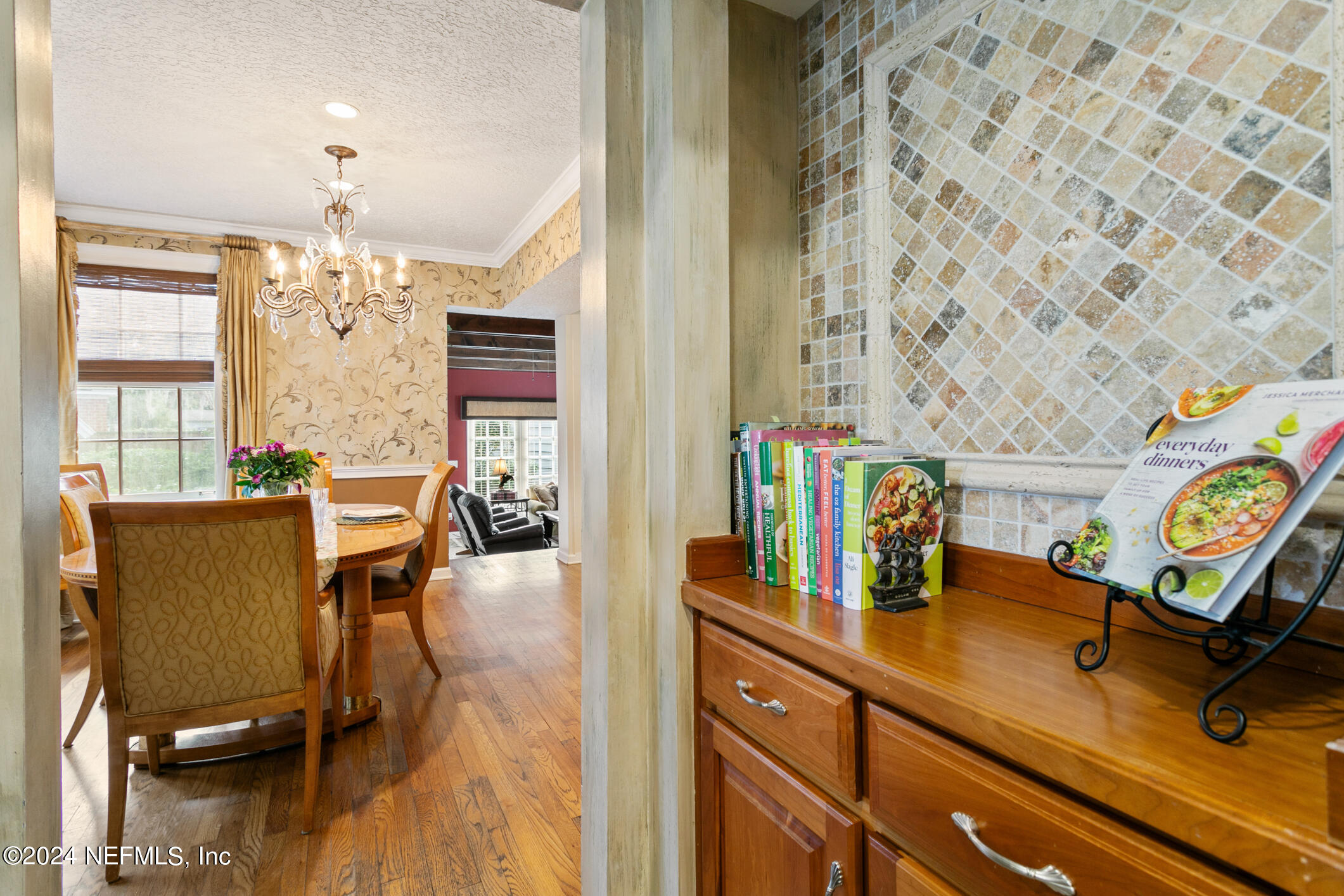 1111 Greenridge Road Jacksonville, FL 32207 - Photo 18 of 73 a view of a dining room with furniture a chandelier and wooden floor