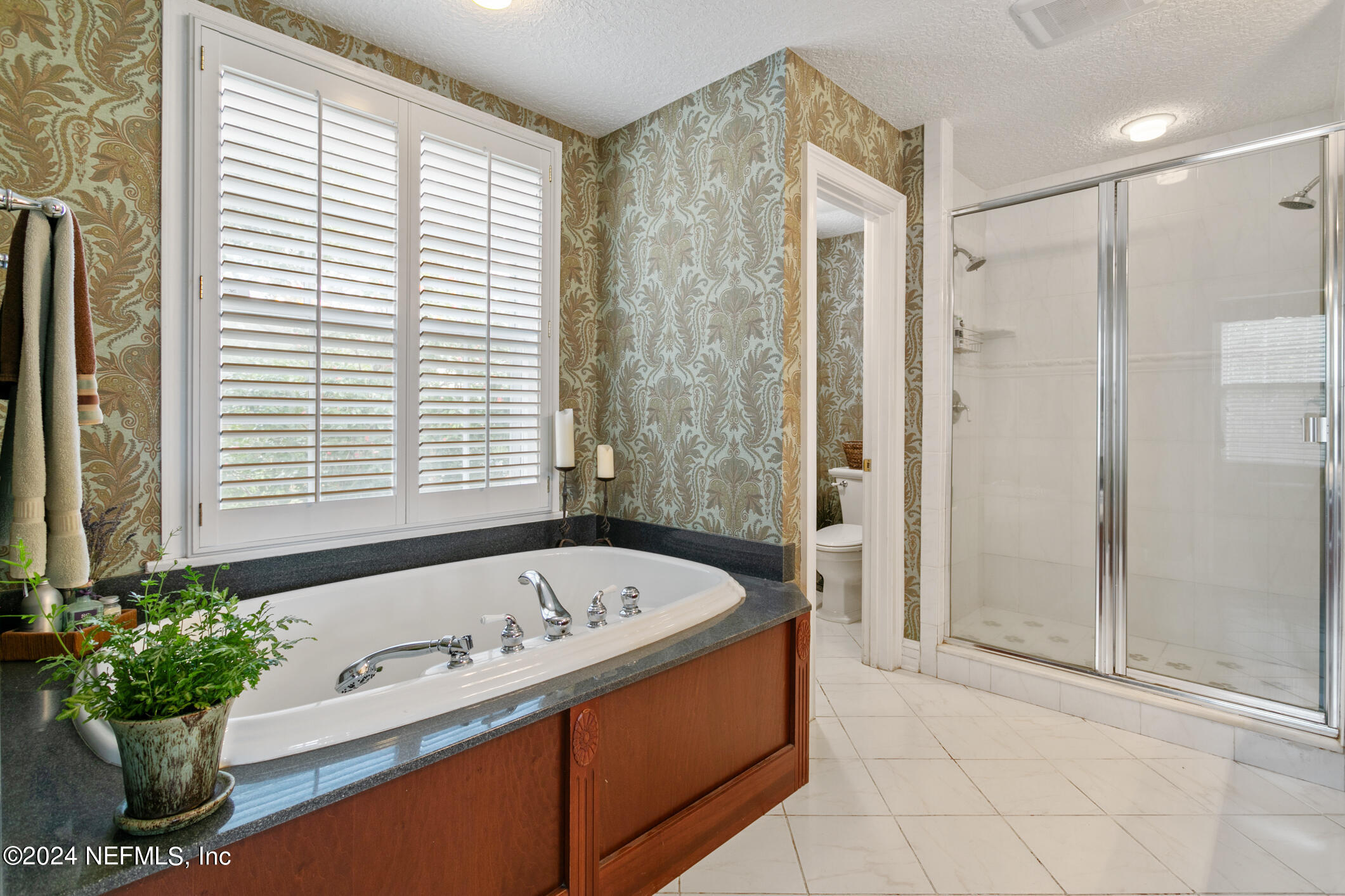 1111 Greenridge Road Jacksonville, FL 32207 - Photo 29 of 73 a bath tub sitting in a bathroom next to a window