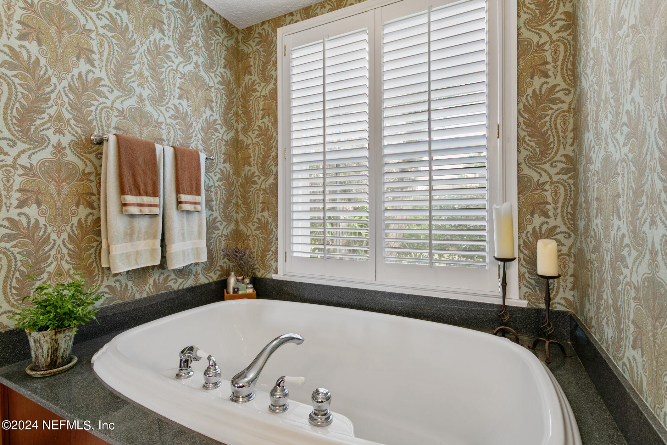 1111 Greenridge Road Jacksonville, FL 32207 - Photo 30 of 73 a bath tub sitting in a bathroom next to a window