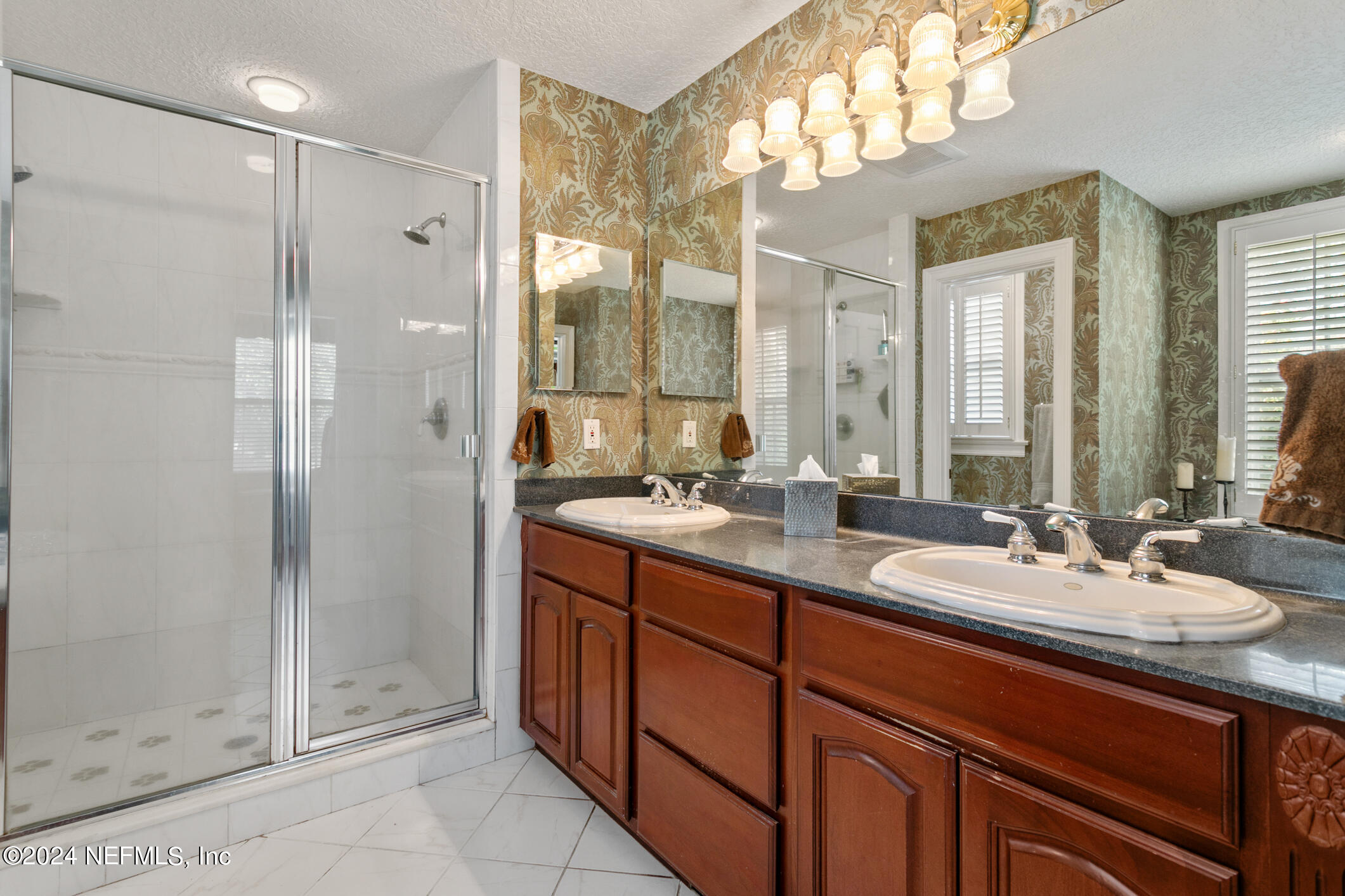 1111 Greenridge Road Jacksonville, FL 32207 - Photo 31 of 73 a bathroom with a double vanity sink mirror and shower