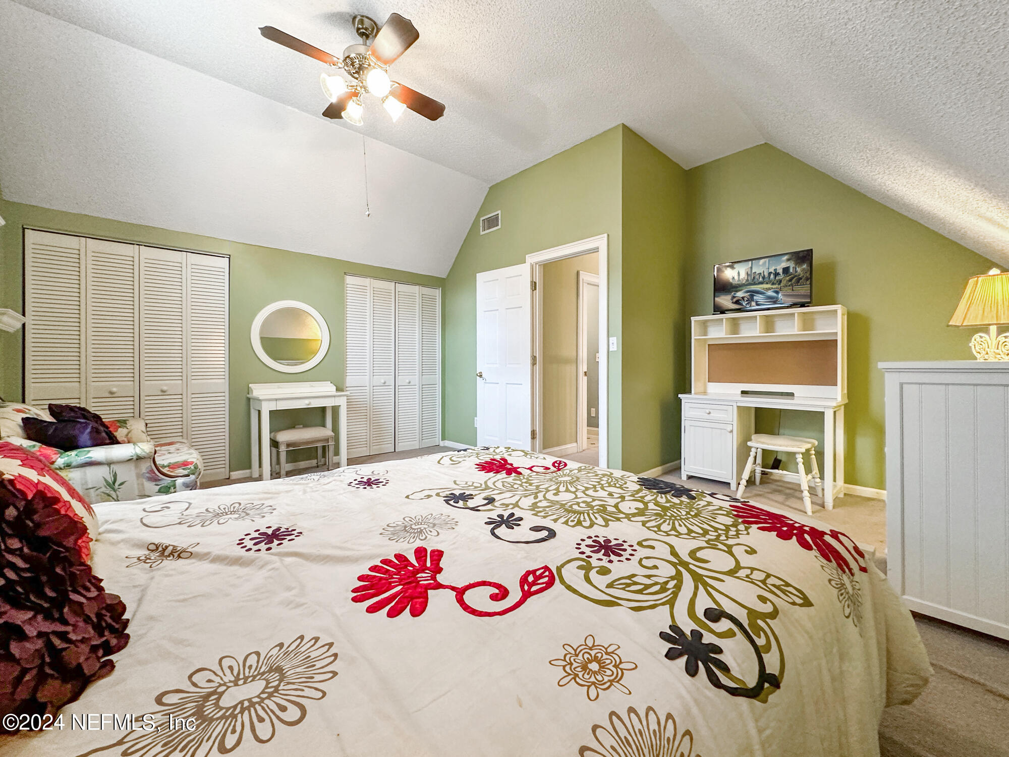 1111 Greenridge Road Jacksonville, FL 32207 - Photo 36 of 73 a bedroom with a bed a dresser and next to a window