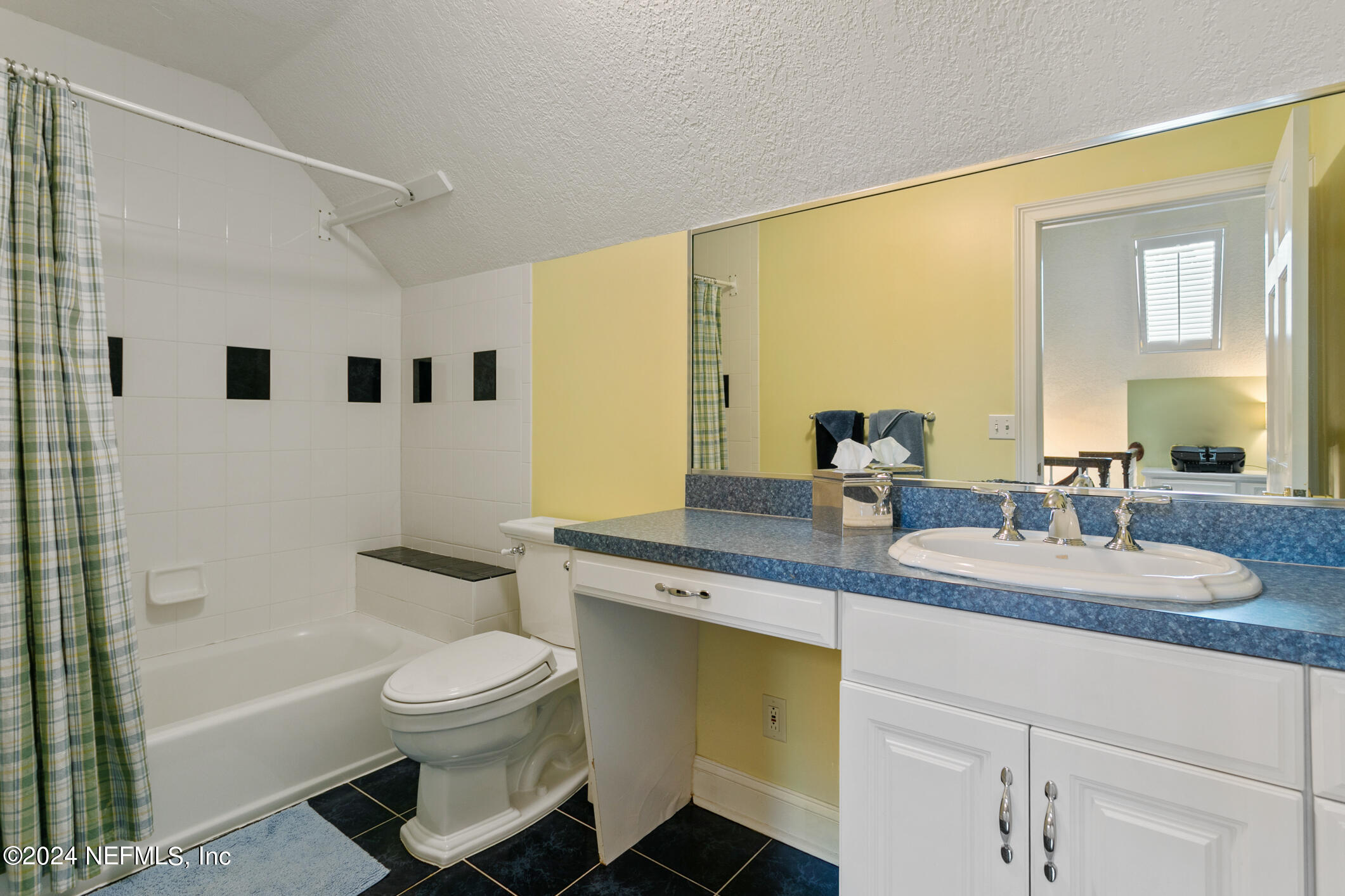1111 Greenridge Road Jacksonville, FL 32207 - Photo 38 of 73 a bathroom with a granite countertop sink mirror vanity bathtub and a toilet