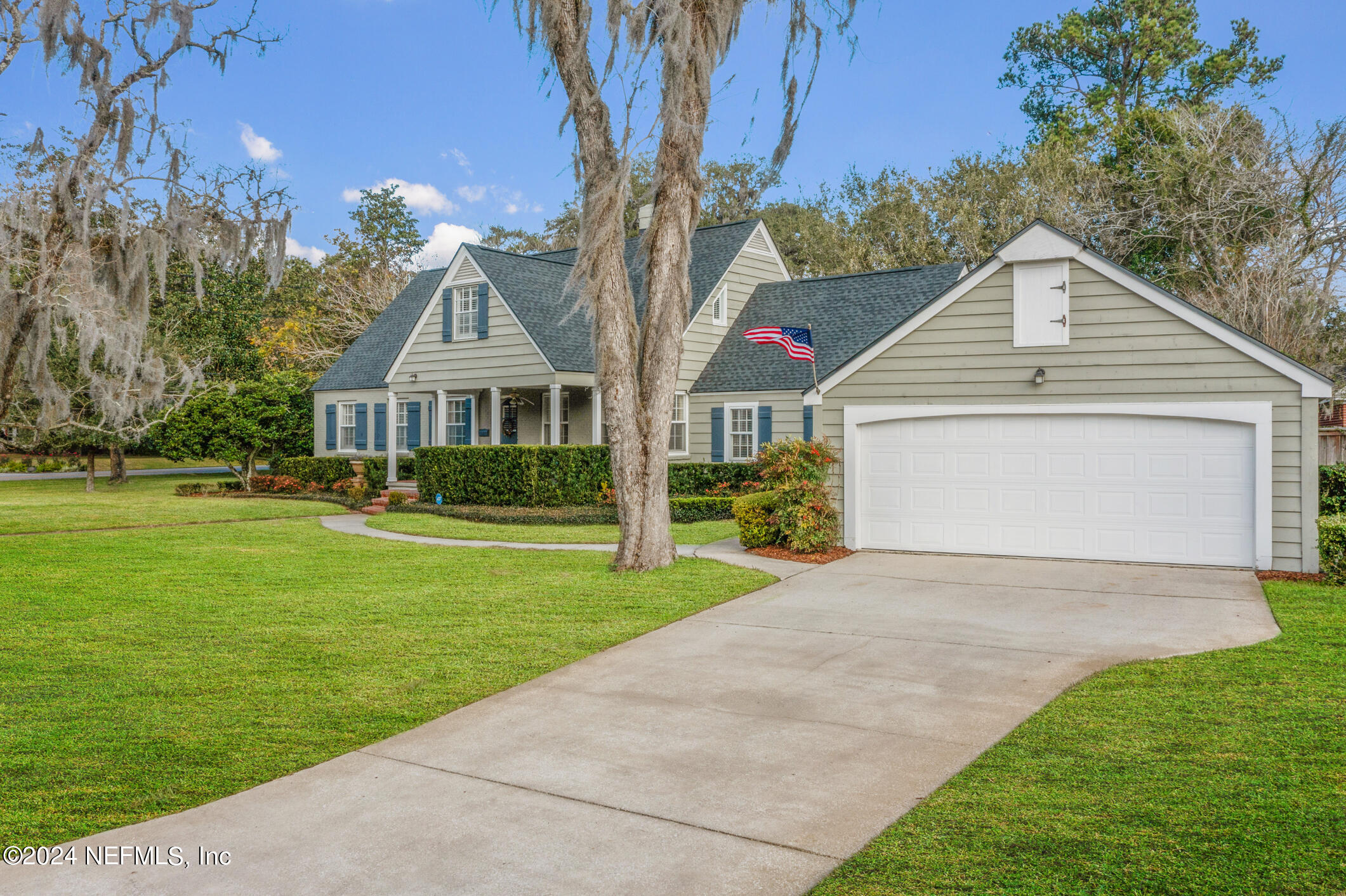 1111 Greenridge Road Jacksonville, FL 32207 - Photo 46 of 73 a front view of a house with a yard and potted plants