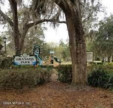 1111 Greenridge Road Jacksonville, FL 32207 - Photo 53 of 73 a view of a street sign under a large tree