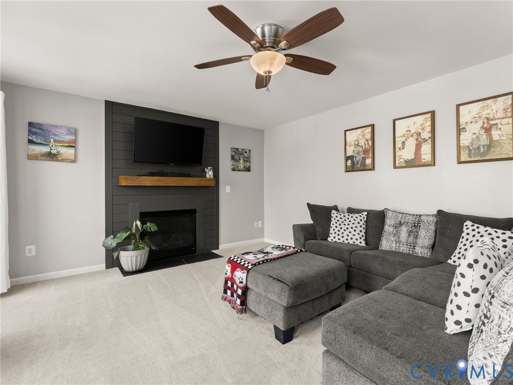126 Reedy Creek Road Louisa, VA 23093 - Photo 23 of 68 The living room features a fireplace with a black
