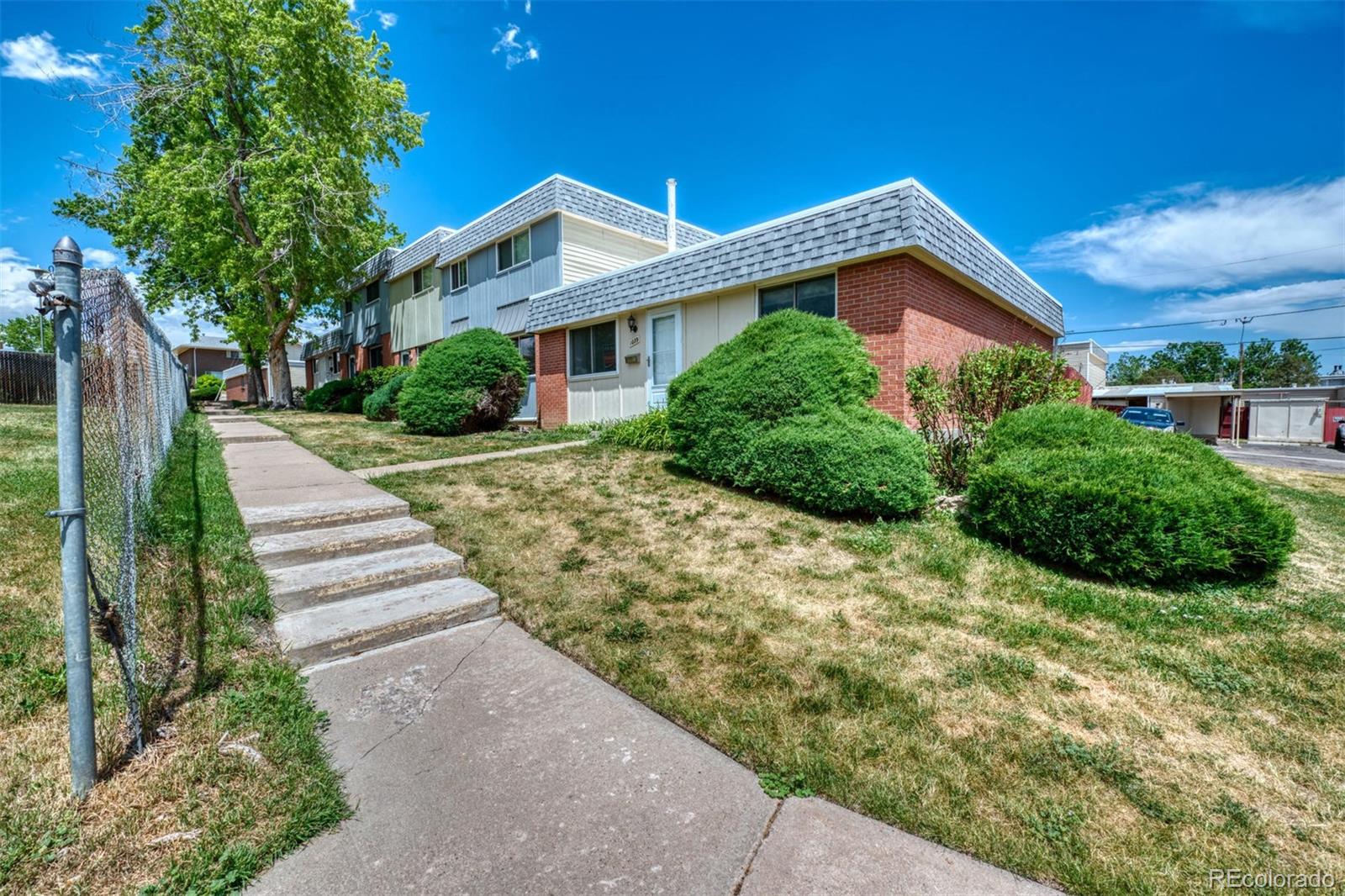 1039 Milky Way Thornton, CO 80260 - Photo 1 of 25 a front view of a house with a yard and trees