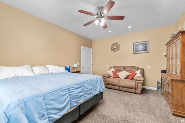 5702 950 North Ogden, UT 84404 - Photo 25 of 36 Spacious room featuring vaulted ceilings, recessed lighting, a ceiling fan, and plush carpeting