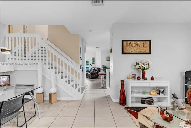 a living room with furniture and a dining table