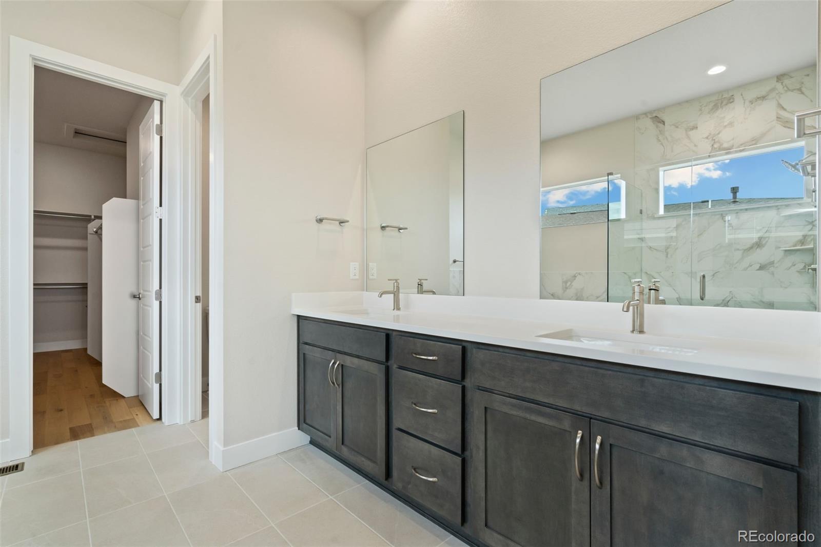 5841 Gianna Drive Timnath, CO 80547 - Photo 12 of 15 a bathroom with a double vanity sink and a mirror