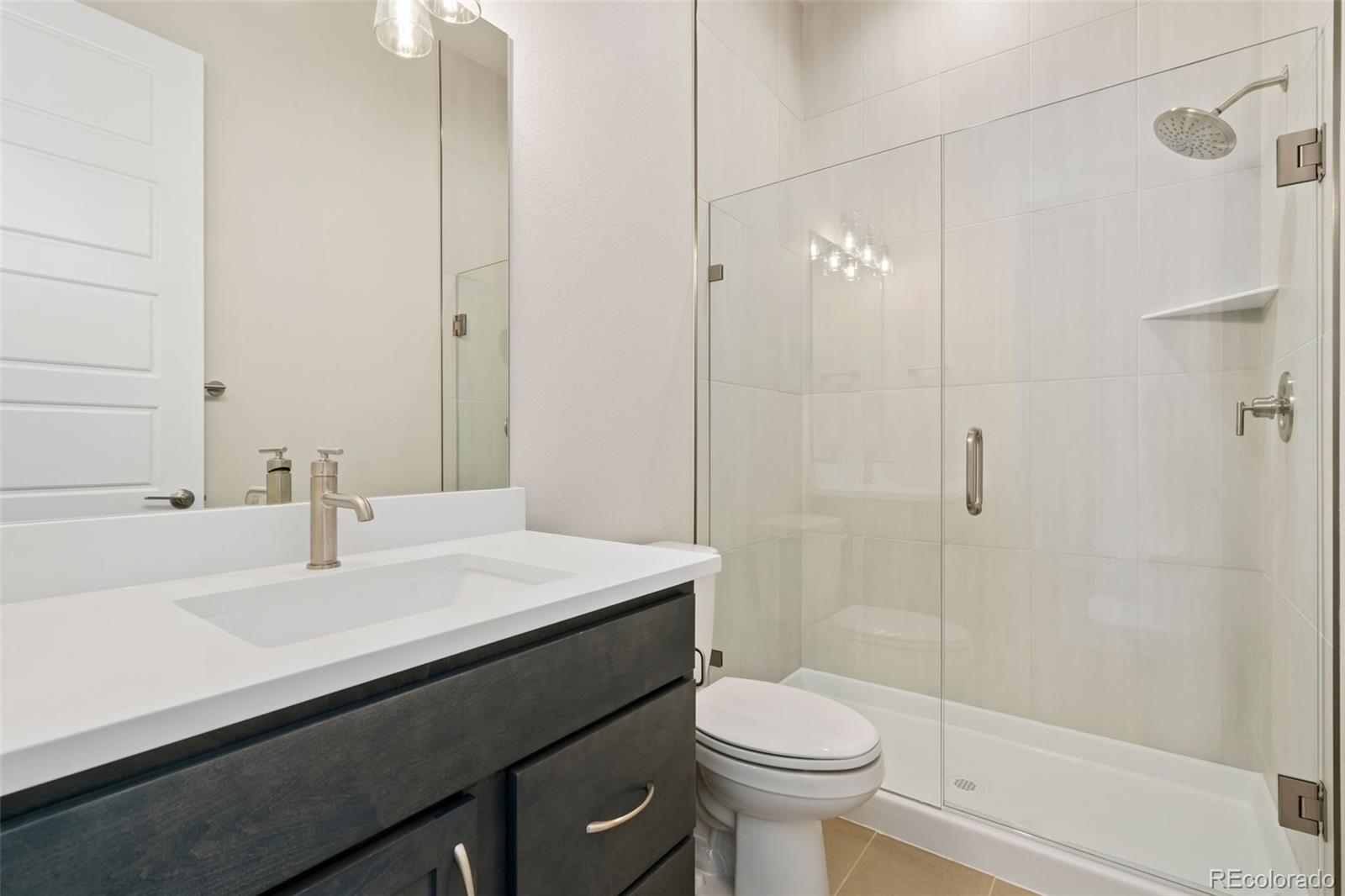 5841 Gianna Drive Timnath, CO 80547 - Photo 3 of 15 a bathroom with a sink a toilet and shower