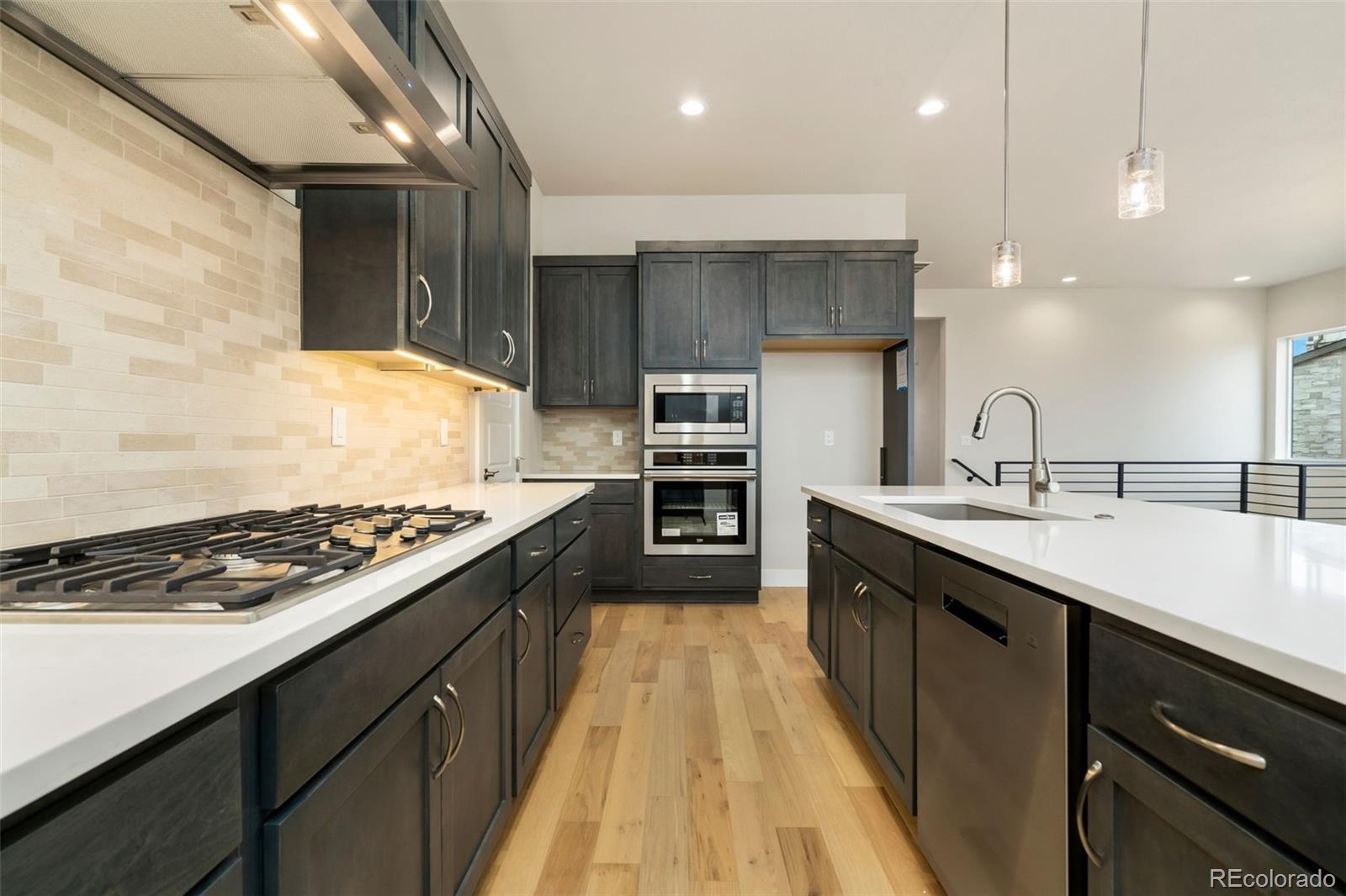 5841 Gianna Drive Timnath, CO 80547 - Photo 10 of 15 a large kitchen with stainless steel appliances granite countertop a stove a sink and a refrigerator