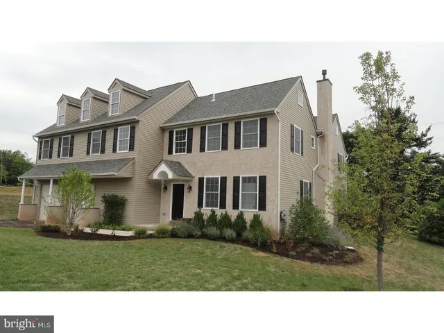 a black and white house with a yard