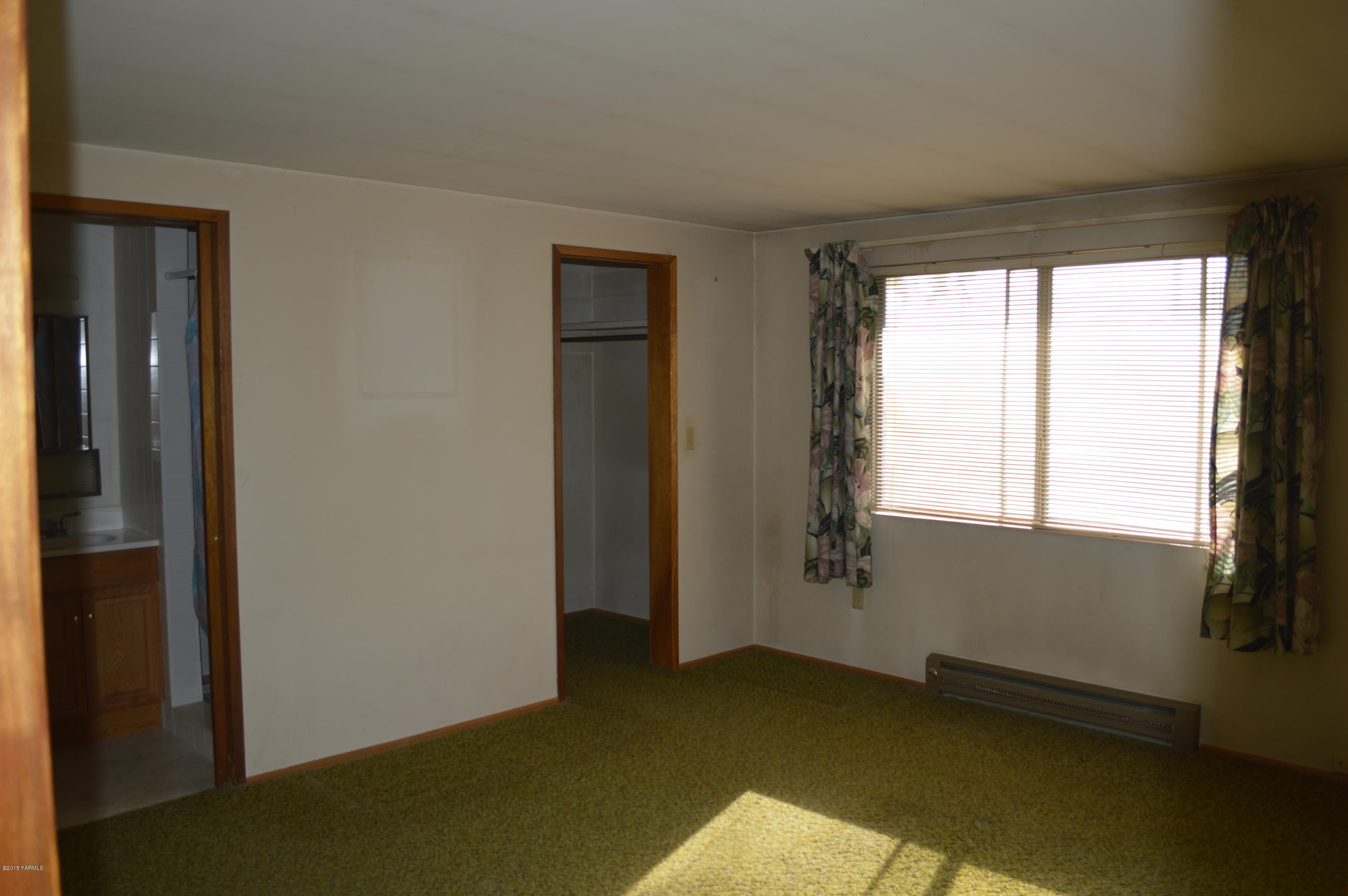 781 Collins Road Selah, WA 98942 - Photo 10 of 23 a view of an empty room with a window