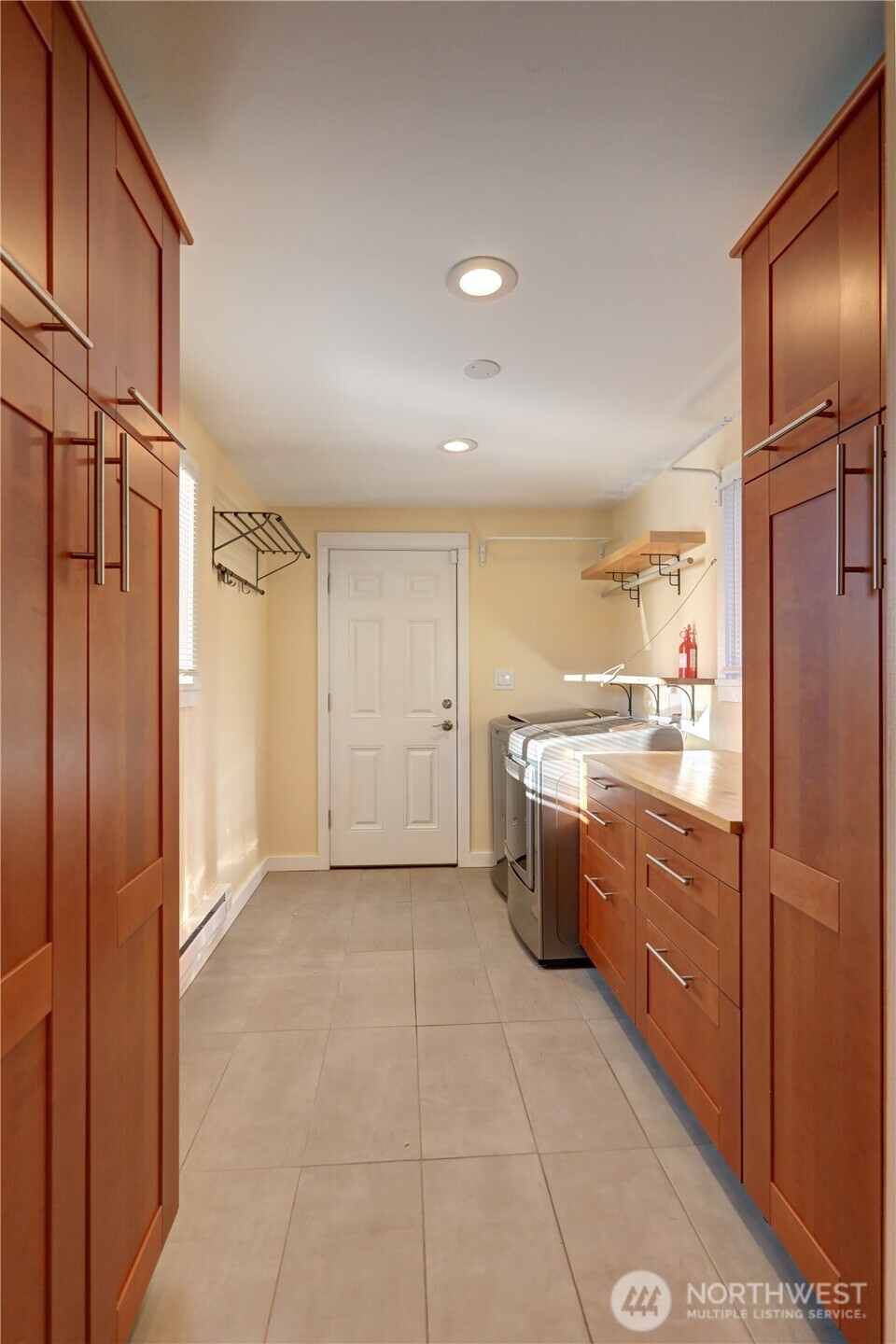 7943 31st Avenue Southwest Seattle, WA 98126 - Photo 13 of 16 a large kitchen with cabinets and stainless steel appliances