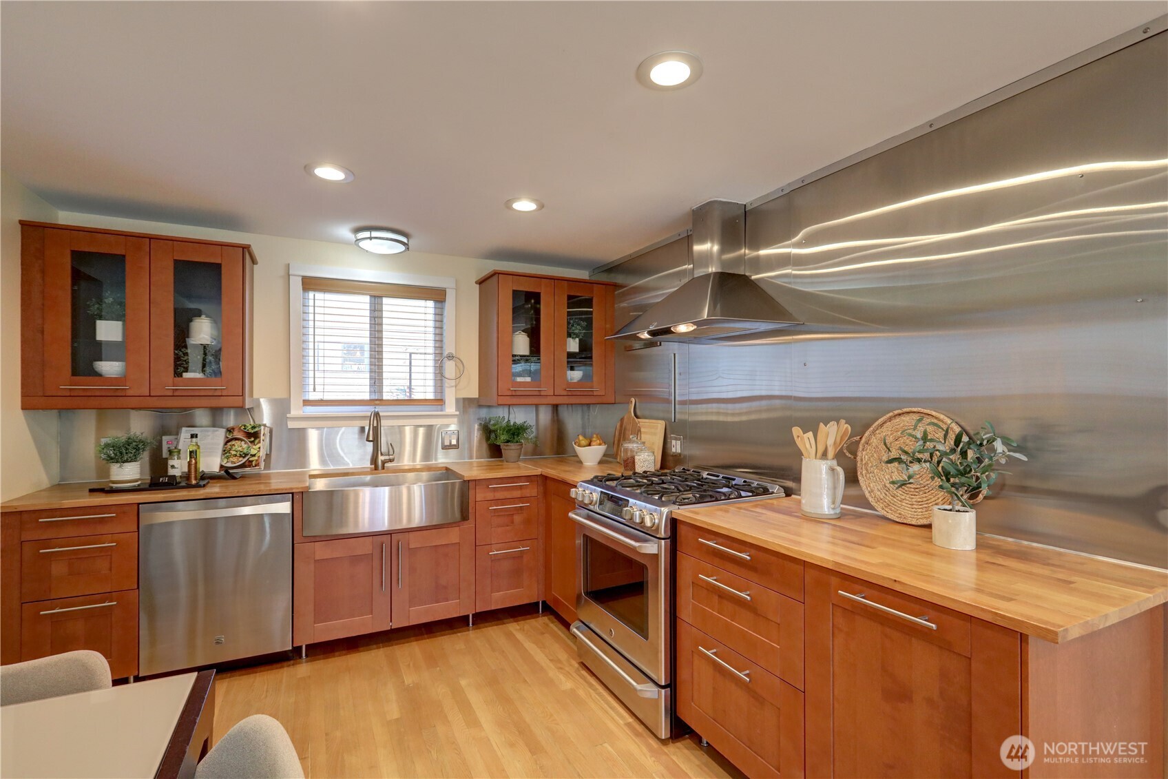 7943 31st Avenue Southwest Seattle, WA 98126 - Photo 5 of 16 a kitchen with stainless steel appliances a sink a stove and cabinets