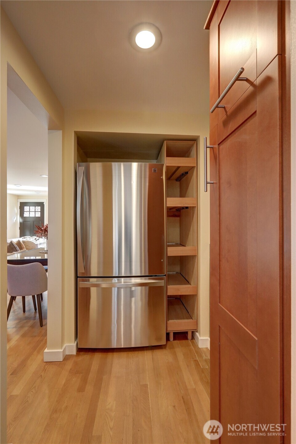 7943 31st Avenue Southwest Seattle, WA 98126 - Photo 6 of 16 a view of a refrigerator in kitchen and wooden floor
