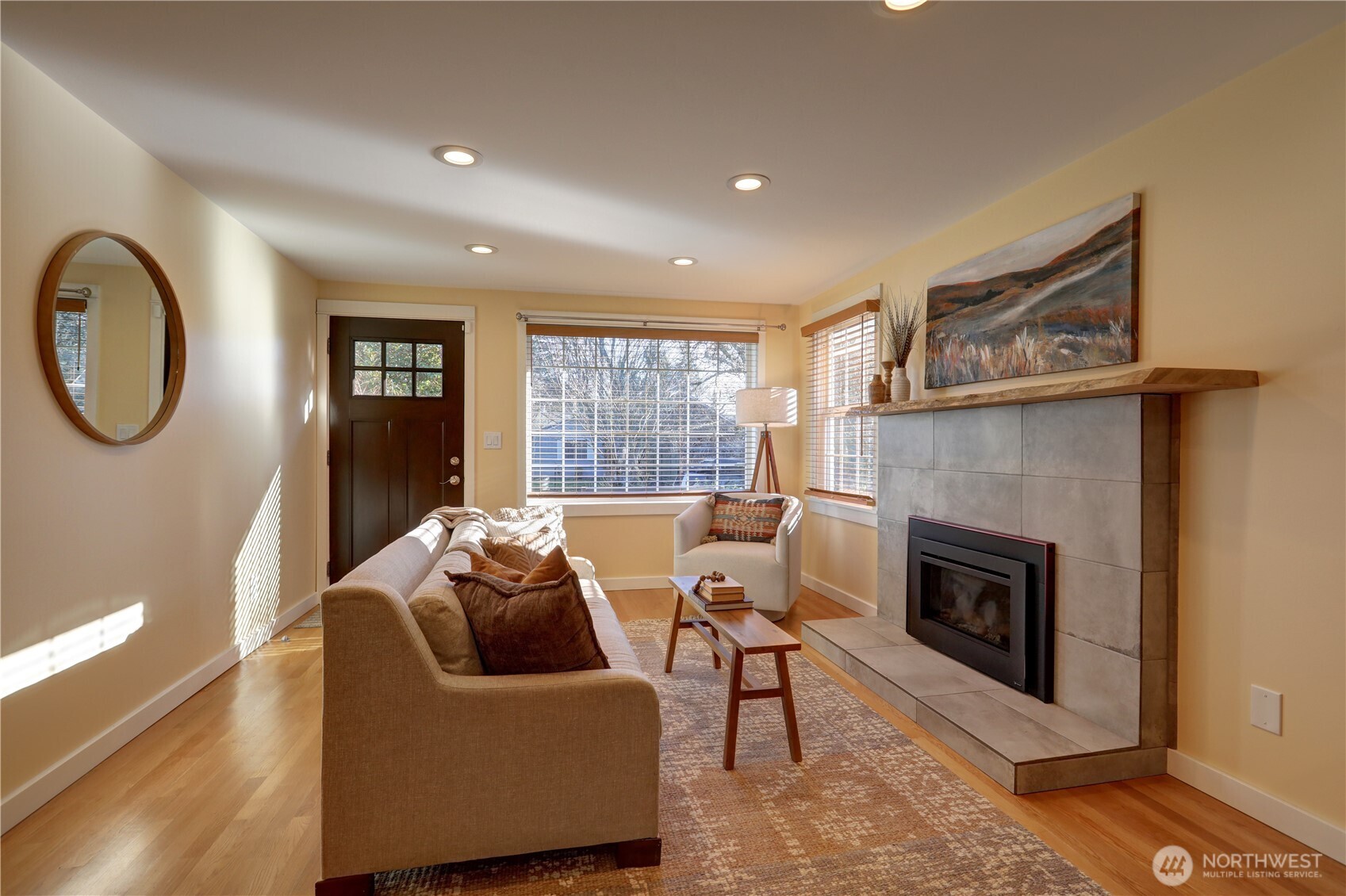 7943 31st Avenue Southwest Seattle, WA 98126 - Photo 8 of 16 a living room with furniture and a fireplace