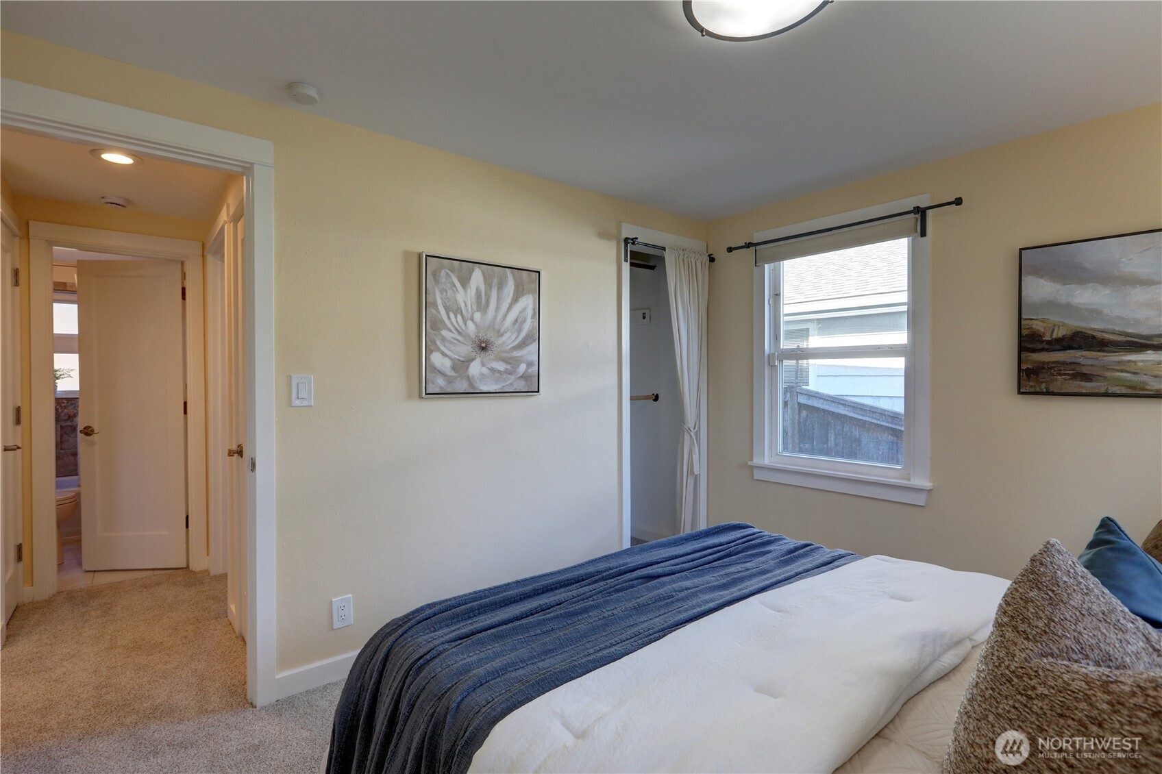 7943 31st Avenue Southwest Seattle, WA 98126 - Photo 10 of 16 a bedroom with a bed and a window