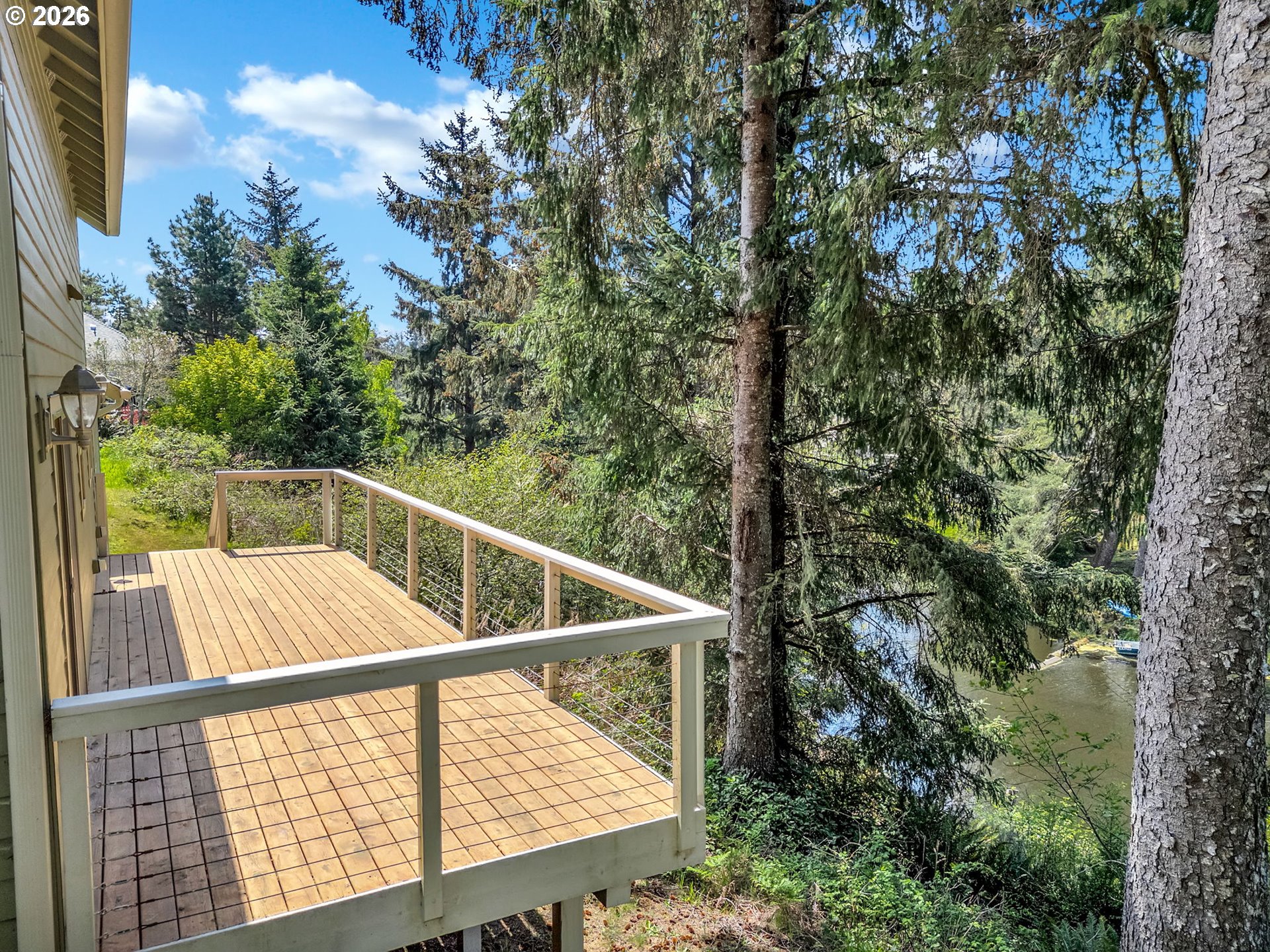 1077 Southwest Ridge Road Warrenton, OR 97146 - Photo 15 of 46 a view of balcony with floor and trees